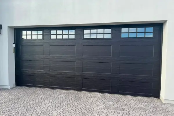 New carriage style garage door installed on a desert home