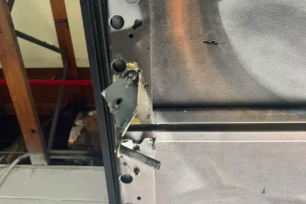 Garage door that came off its track being repaired