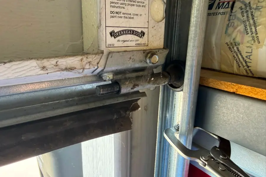 A new nylon garage door roller seated in the track of an East Valley garage door