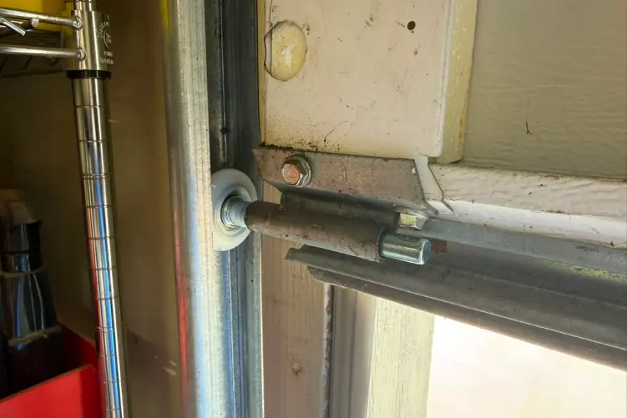 Worn garage door roller removed from a door that was binding in the track