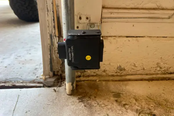 Garage door safety sensor near the floor
