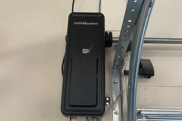 LiftMaster wall-mounted jackshaft opener beside a garage door