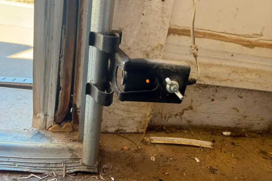 Safety sensors mounted near the floor on each side of a garage door