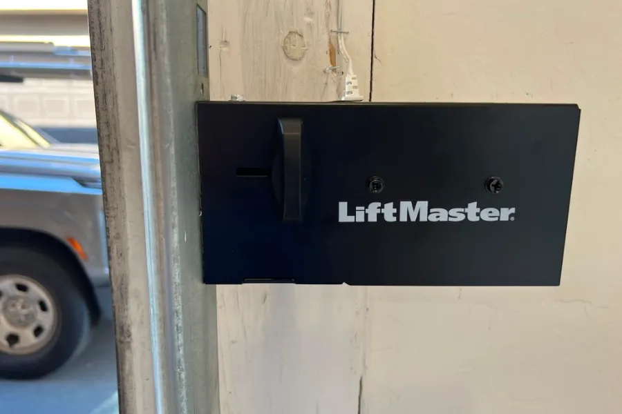 LiftMaster automatic side lock installed on a Chandler garage door jamb