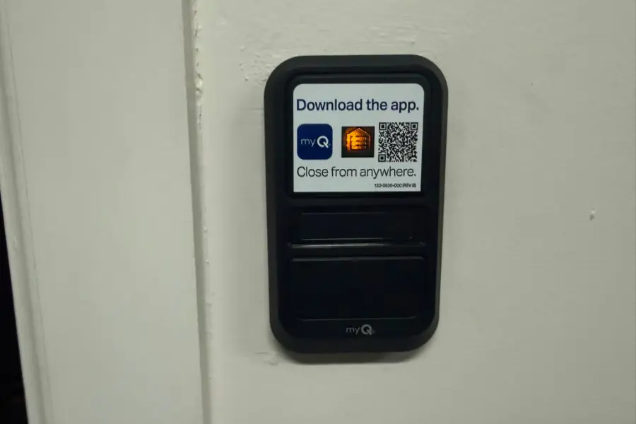A LiftMaster wall control panel mounted inside a Tempe garage