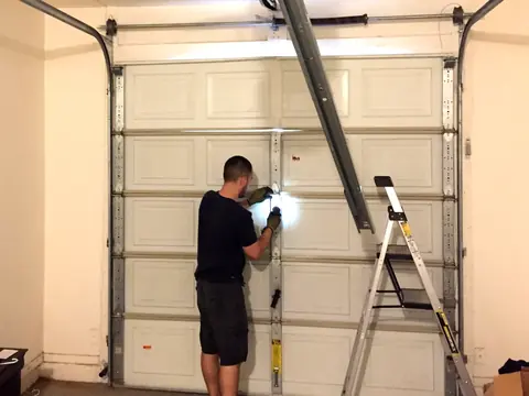 Technician responding to an emergency garage door repair call in Phoenix