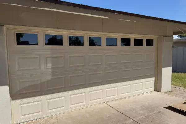 Newly installed garage door on a stucco home