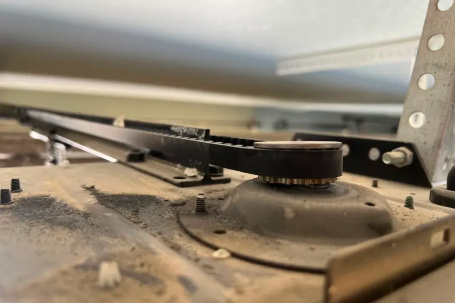The drive gear inside an opener head with the cover removed