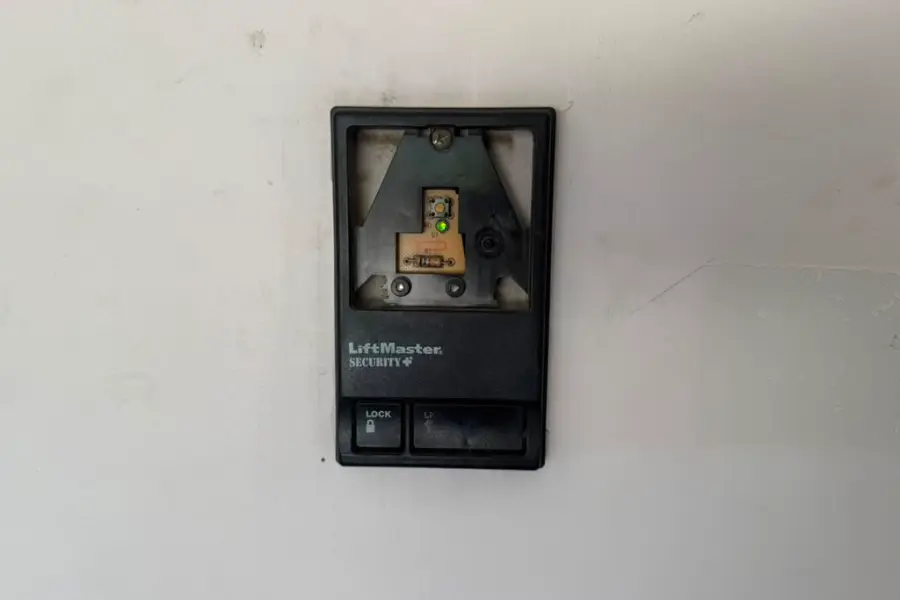 A replaced garage door wall control wired and mounted on a Gilbert garage wall
