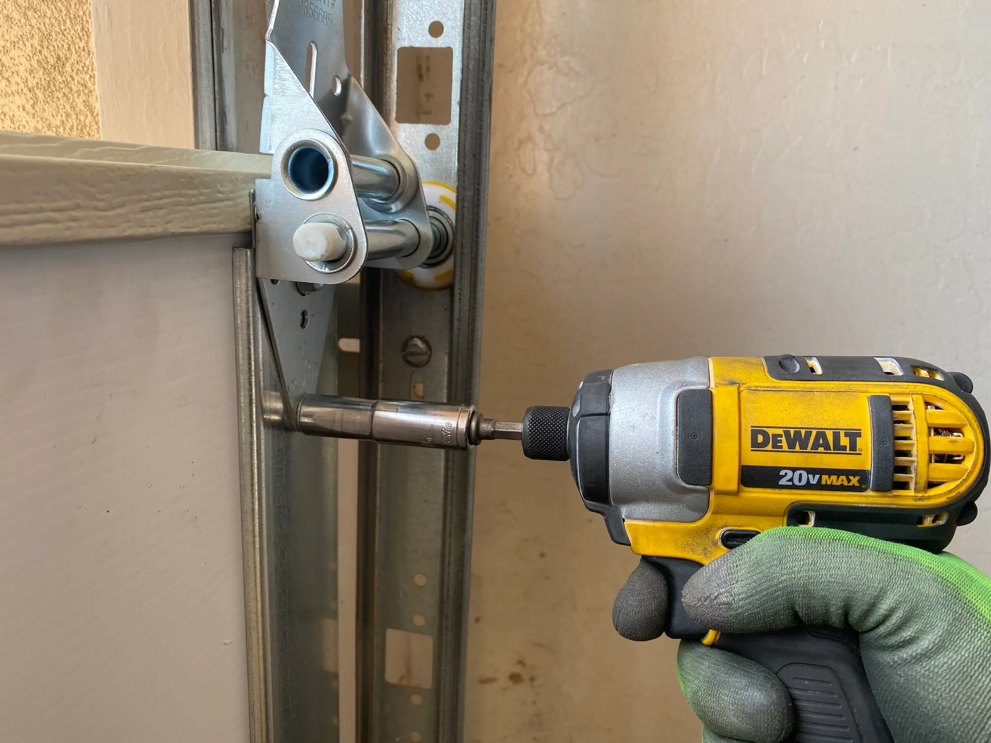 Garage Door Service Technician Repairing Door